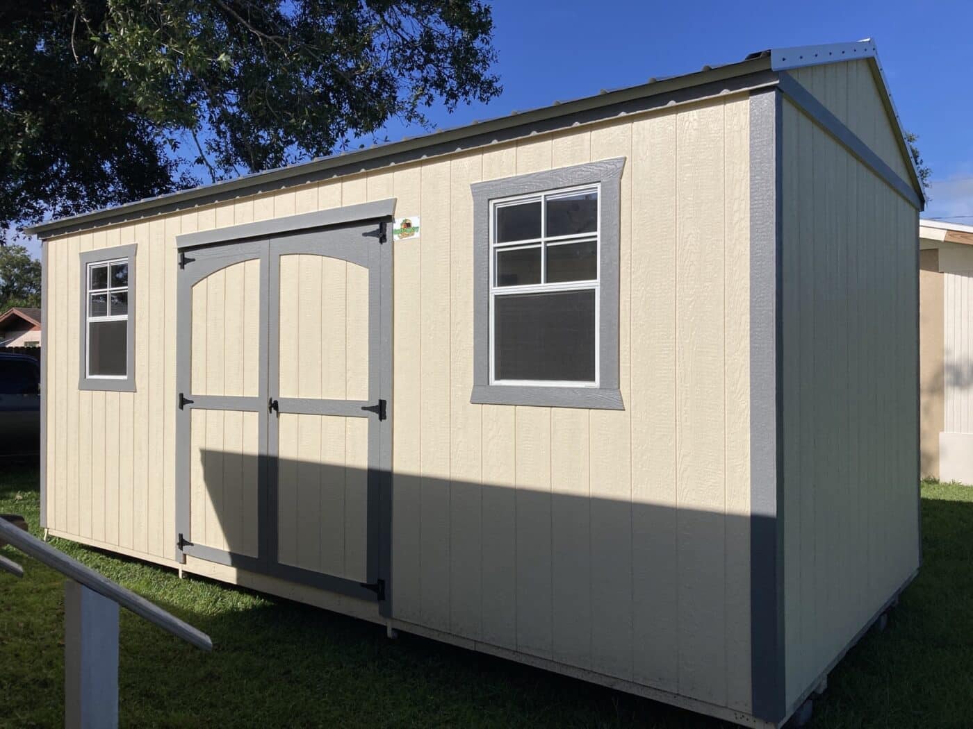 a beige 12x24 storage shed with grey trim in florida