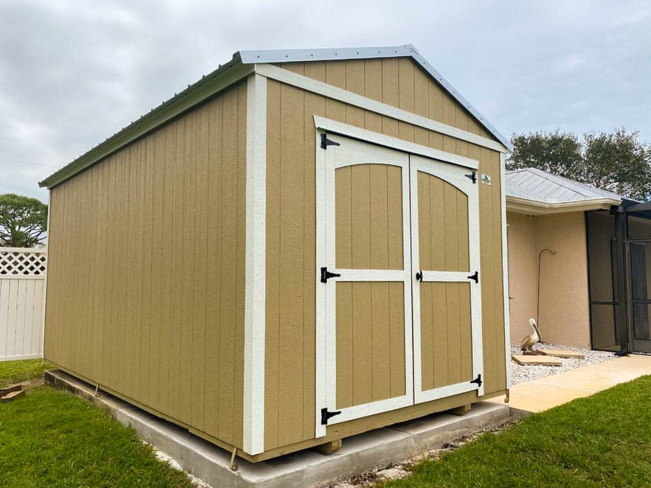 a beige shed with white trim in florida