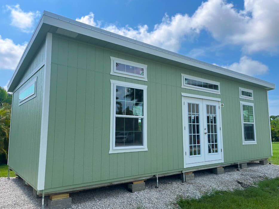 a green studio shed that adheres to the florida wind zones rules