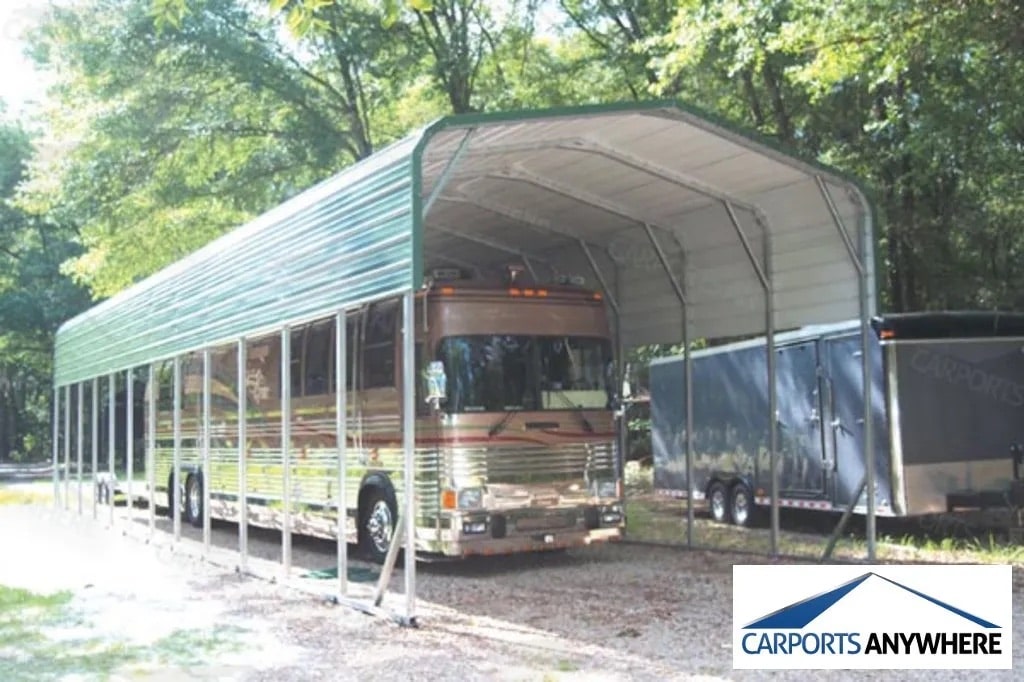a long green metal carport with an rv parked below it