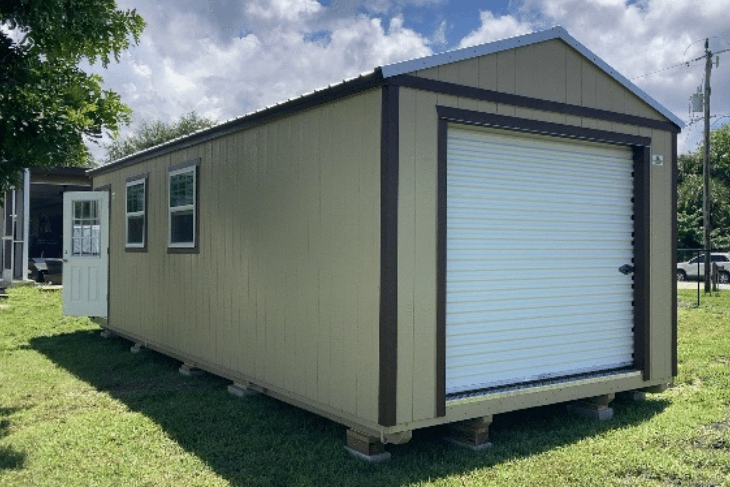 beige with brown and white garage door, windows, and side door in wauchula fl