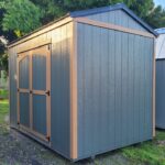 a grey-blueish storage shed with light brown trim with it's back up against another shed in fort lauderdale fl